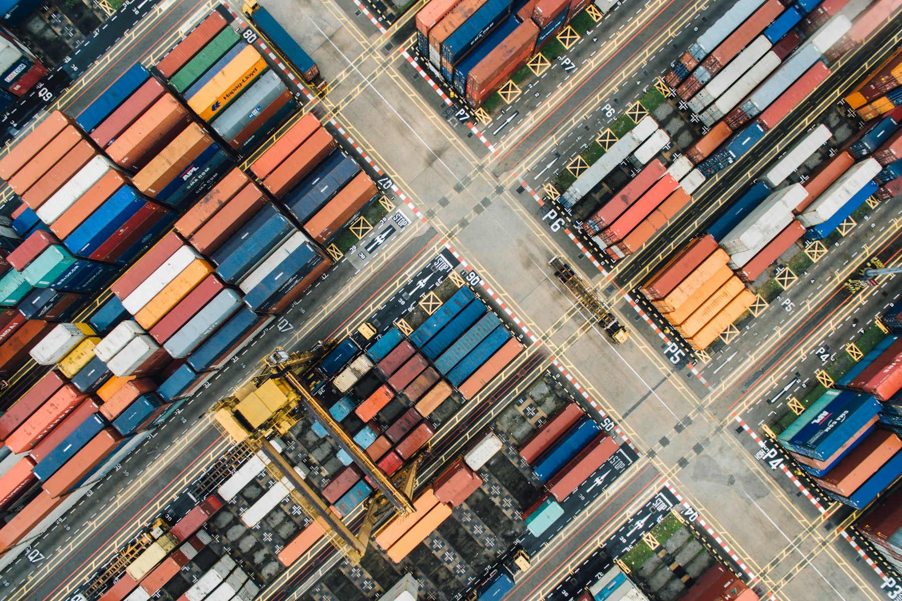 An aerial view of shipping containers and intersecting routes at a freight terminal